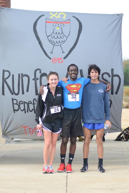 Allison Pulliam, junior broadcast journalism major and third place winner, Jeremiah Murila, junior engineering major and second place winner, and Anthony Aguinaga, graduate pharmacy student and first place winner, at the Make-a-Wish 5K. - Photo by Meg Rushing
