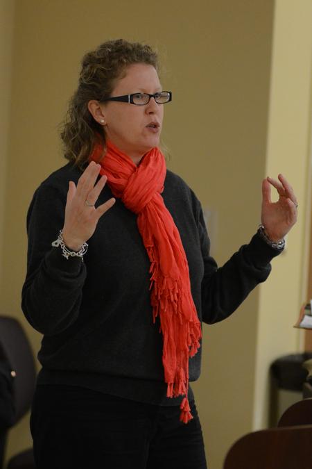 Katie Woodruff, associate director of athletics, explains to her audience how sports can help with character formation for the final lecture in this year's Sports and Culture Town and Gown series. - Photo by Emily Stookey
