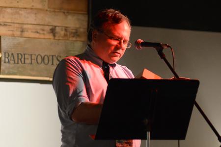 David Malone, associate professor of English and acting department chair, begins the reading of Dickinson's A Christmas Carol at the event put on by the English Department in Barefoots Joe.  - Photo by MiKalla Cotton