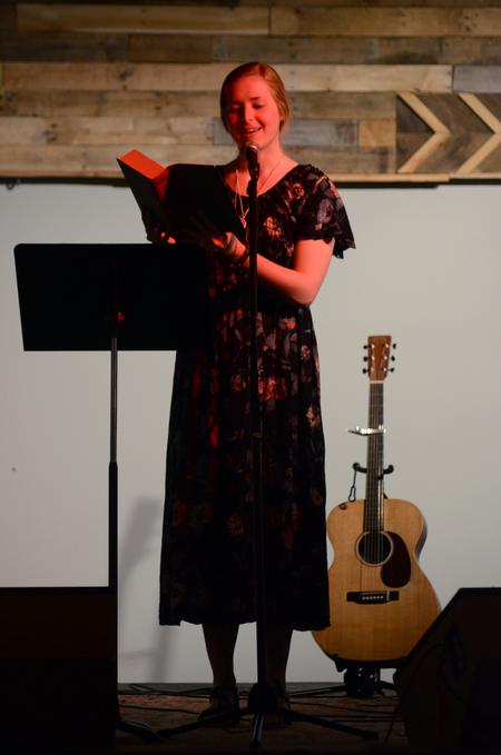 Kelsie Leaf, junior public relations major, reads at the English Department's A Christmas Carol reading and cookie exchange event in Barefoots Joe. - Photo by MiKalla Cotton