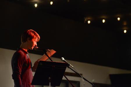 Andrew Gray, visiting instructor of English, reads at the English Department's A Christmas Carol reading and cookie exchange event in Barefoots Joe. - Photo by MiKalla Cotton