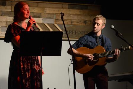 Kelsie Leaf, junior public relations major, and Zach Lancaster, junior art major, sing at the English Department's A Christmas Carol reading and cookie exchange event in Barefoots Joe. - Photo by MiKalla Cotton