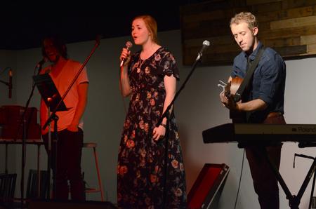 Rob Griffith, senior English major, Kelsie Leaf, junior public relations major, and Zach Lancaster, art major, perform at the English Department's A Christmas Carol reading and cookie exchange event in Barefoots Joe. - Photo by MiKalla Cotton