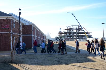 A tour group passes through the quads during Preview Day as construction on the new library goes on in the background. - Photo by MiKalla Cotton