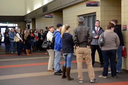 David Taylor, sophomore chemistry major, leads a group through the Student Union Building ahead of other tour groups on Preview Day. - Photo by MiKalla Cotton