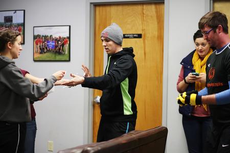 Riley Pope, junior DMS major, gets the 3rd clue for the res-life Amazing Race event held over January term. Pope's team went on to win the challenge. - Photo by Kristi McMurry Woody