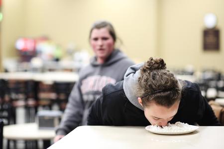 Lauren Bone, junior psychology major, tries to find two pieces of gum in a whipped cream pie without using her hands. This challenge was part of Union's The Amazing Race event organized by Residence Life. - Photo by Kristi McMurry Woody