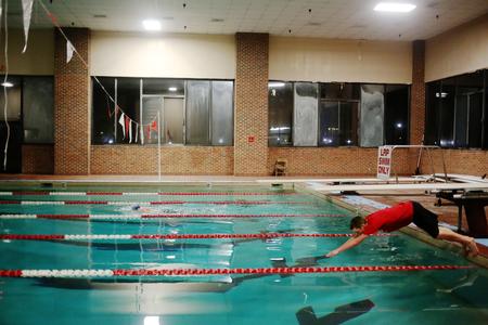 Isaac Lisle, senior conservation biology major, dives into the pool during the last challenge of res-life's Amazing Race. - Photo by Kristi McMurry Woody
