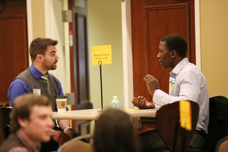 Kenan Keller, senior history major, talks with a WalMart representative during the College to Career event hosted by the Vocatio Center.
 - Photo by Kristi McMurry Woody
