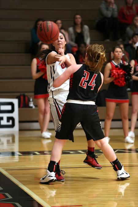 Chelsea Bodiford passes around a Valdosta State University defender during a game in the Fred Delay Gymnasium. The Lady Bulldogs won the game 77-66. - Photo by Kristi McMurry Woody