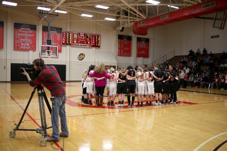The Lady Bulldogs gather with the Valdosta State University Lady Blazers for prayer after their basketball game. - Photo by Kristi McMurry Woody