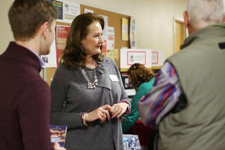 Jean Marie Walls, professor of language and department chair, talks with guests at the External Study Fair. - Photo by Kristi McMurry Woody