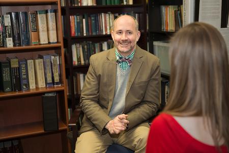 Brad Green, associate professor of Christian thought and tradition, meets with a student in his office.  - Photo by Kristi McMurry Woody