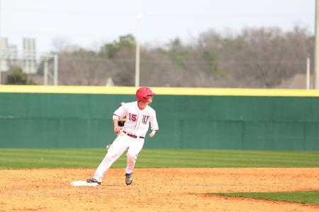 Shane Wilder rounds second looking for the signal to continue during a game against Henderson State. - Photo by Kristi McMurry Woody