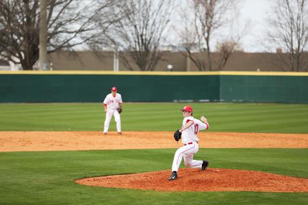 Preston Thompson winds up for a pitch during a double header against Henderson State. - Photo by Kristi McMurry Woody