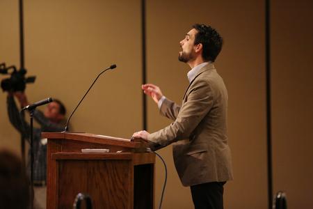 Cody Curtis leads guests of the Ryan Center Bible Conference in a hymn. - Photo by Kristi McMurry Woody