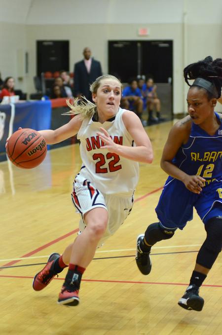 Amy Philamlee, senior sports medicine major and guard, drives toward the goal in a tournament game. - Photo by Meg Rushing
