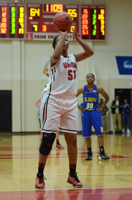 DeAnna Thompson, senior forward and physical education and health major, takes a free throw shot in a tournament game. - Photo by Meg Rushing