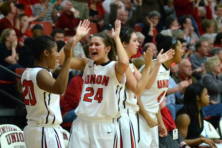 Keren Boyce, freshman guard, and Natalie Smith, sophomore guard and history major, celebrate a point for the Lady Bulldogs  in a tournament. - Photo by Meg Rushing