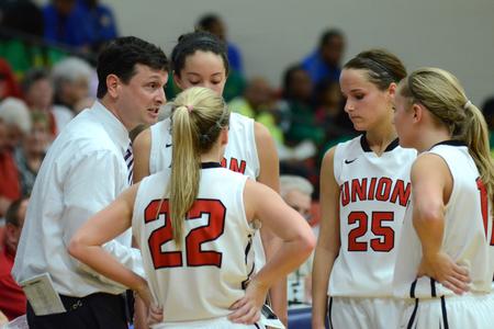 Mark Campbell, head women's basketball coach, talks with his players during a time-out in a tournament game. - Photo by Meg Rushing