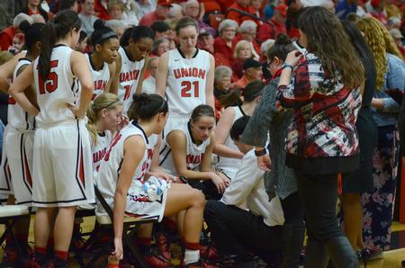 The women's basketball team takes a time-out to look over plays during a tournament game. - Photo by Meg Rushing