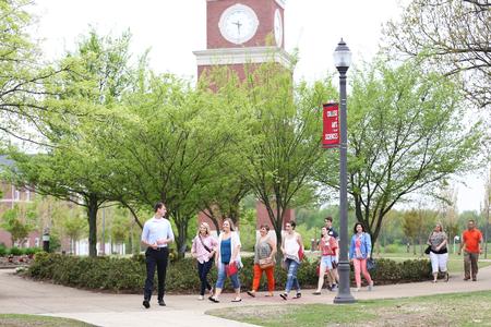 A tour group walks past the bell tower during a campus tour on Preview Day. - Photo by Kristi McMurry Woody