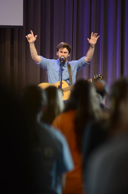 Nathan Shoemaker, junior music major, leads worship during the Go Trip Report chapel service. - Photo by MiKalla Cotton