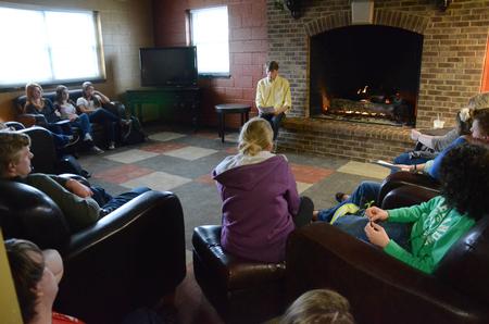 Hunter Martin, senior accounting major, shares his readings during the English portion of the Scholarship Symposium in the fireplace room of the Bowld Student Commons. - Photo by MiKalla Cotton