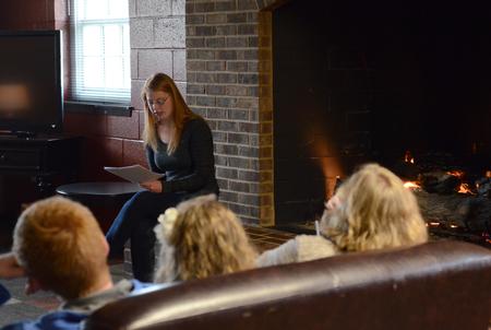 Alexis Piscatello, senior music major, reads various pieces during the English portion of the Scholarship Symposium in the fireplace room of the Bowld Student Commons. - Photo by MiKalla Cotton