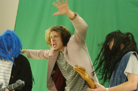 Freshman Joseph Lambach doesn't need a wig for his performance in a green screen video during Fall Fest '04. - Photo by Jonathan Blair