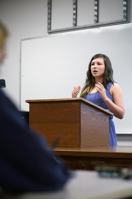 Sarah Lawler, junior art major, discusses her exploration within the medium of paint at the Twelfth Annual Scholarship Symposium. - Photo by Amanda Rohde