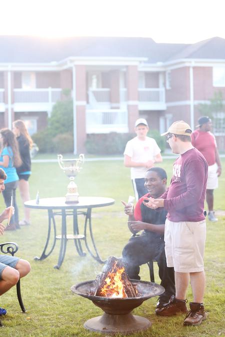 Students gather around a fire during Residence Life's Field Day, where the winner of the Union Cup would be announced.  - Photo by Kristi McMurry Woody
