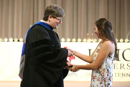 Chris Blair, professor of communication arts and coordinator of DMS, presents Elizabeth Fletcher, senior DMS major, with an academic excellence medal. - Photo by Kristi McMurry Woody
