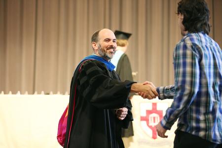 George Moss, associate professor of mathematics and department chair, shakes hands with Jamie Fox, senior mathematics major and winner of the academic excellence award in mathematics at Awards Day. - Photo by Kristi McMurry Woody
