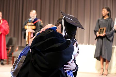 Upon being named 2015 Faculty Member of the Year, Ashley Blair, assistant professor of communication arts, hugs her husband Chris, professor of communication arts. - Photo by Kristi McMurry Woody