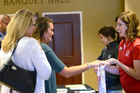 Karen Taylor, associate director of student leadership and engagement, welcomes a new student to summer orientation. - Photo by Meg Rushing