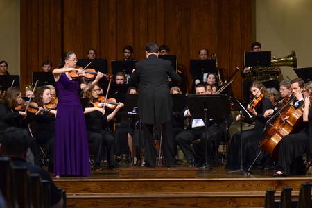 Paige Tang, senior music major, performs the Conus Violin Concerto accompanied by the university orchestra in a concert at First Baptist Church in Jackson. - Photo by Meg Rushing