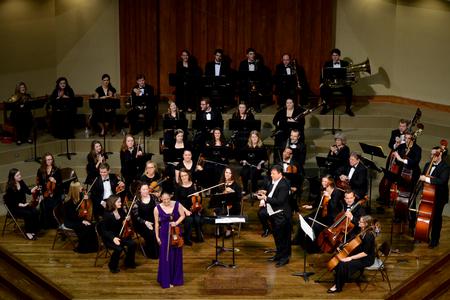 Paige Tang, senior music major, stands for applause after her performance of the Conus Violin Concerto. - Photo by Meg Rushing
