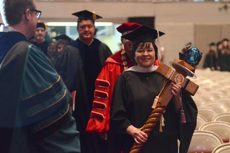 Ashley Blair, faculty of the year, carries the mace during the processional at Union University's 190th Spring Commencement Service. - Photo by Emily Stookey