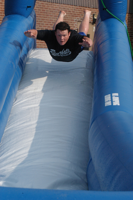 Freshman Jeff McCormick plunges head first into the water on the aqua slide during Fall Fest '04. - Photo by Jonathan Blair