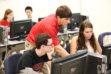 Georg Pingen, associate professor of engineering, helps students with some 3D modeling software. - Photo by Kristi McMurry Woody