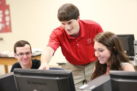 Georg Pingen, associate professor of engineering, helps students with some 3D modeling software. - Photo by Kristi McMurry Woody