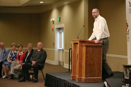 Brian Carrier, vice president for student life and dean of students, thanks Paul Descanes for his years of service at Union as part of the reception honoring this year's retirees. - Photo by Kristi McMurry Woody