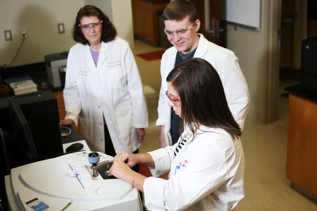 Sally Henrie (left), professor of chemistry, works with a couple of students in the lab. - Photo by Kristi McMurry Woody