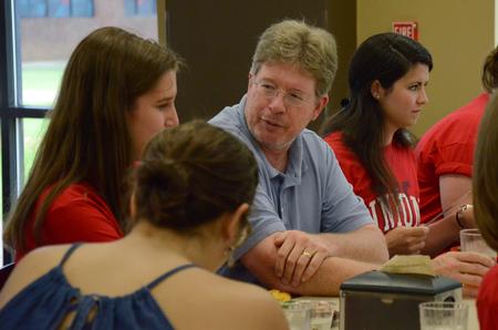 Mark Bolyard, professor of biology and department chair, talks to freshmen biology majors at the academic department dinner in Brewer dining hall. - Photo by Elizabeth Wilson