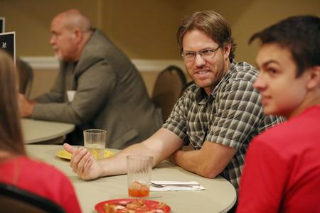 Steve Halla, assistant professor of art, talks with new students about majoring in art at the Dinner with your Department event during Welcome Week. - Photo by Kristi McMurry Woody