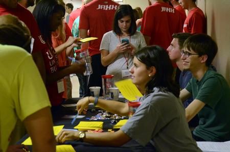 Clare Williams, senior intercultural studies major, and Jared Dauenhauer, assistant director of student leadership and engagement, hand out surveys about Welcome Week during the Student Organization Fair. - Photo by Elizabeth Wilson