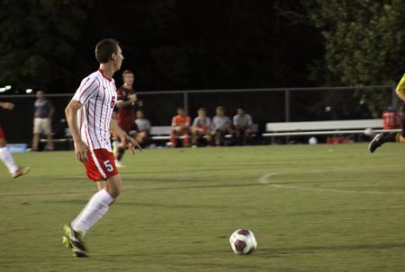 Rodrigo Zonta, sophomore physical education and health major, takes a quick look to find his teammate before passing the ball in the men's home opener. - Photo by Sol Bee Park
