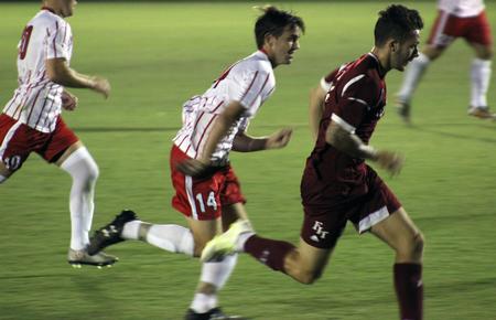 John Crawford, freshman, tries to run toward the ball before his opponent, an athlete from Florida Institute of Technology. - Photo by Sol Bee Park