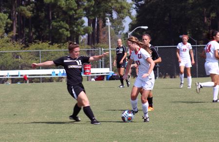 Katlyn Dupree, junior English major, manages to keep the ball away from her opponent, an athlete from Mckendree University. - Photo by Sol Bee Park